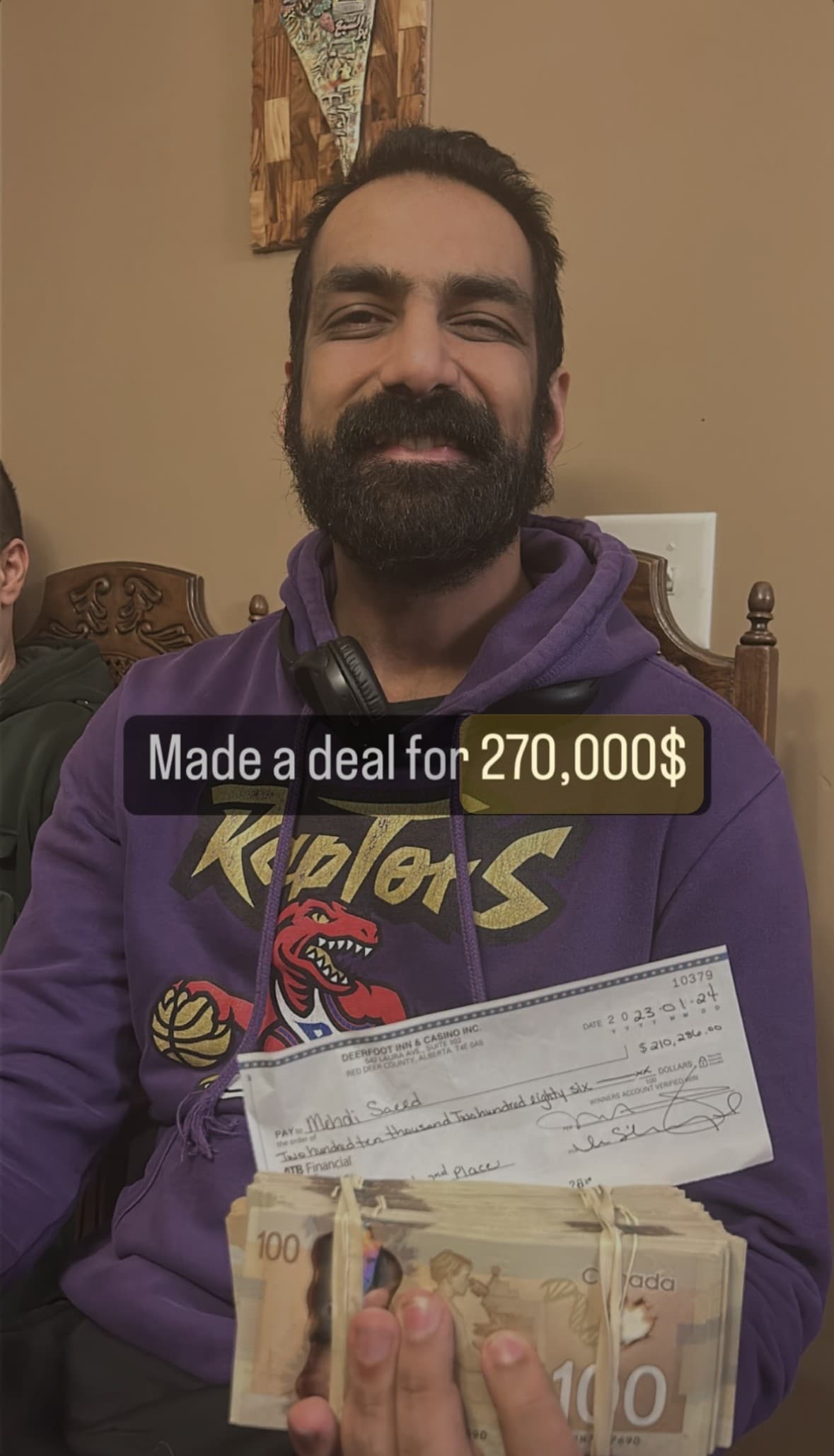 Adam holding the winner's cheque from Deerfoot Inn & Casino